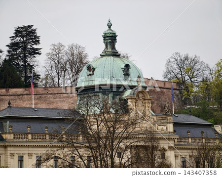 Historical architectural visuals. Classical building features captured beneath cloudy sky setting 143407358