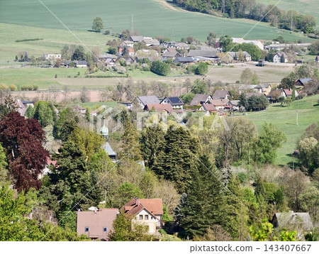 Bright woodland community landscape. Sundrenched village among woods with scenic gardens and paths 143407667