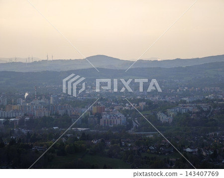 Evening horizon merges distant hills with turbines and factories for transition narratives Evening horizon merges distant hills with turbines and factories for transition narratives 143407769
