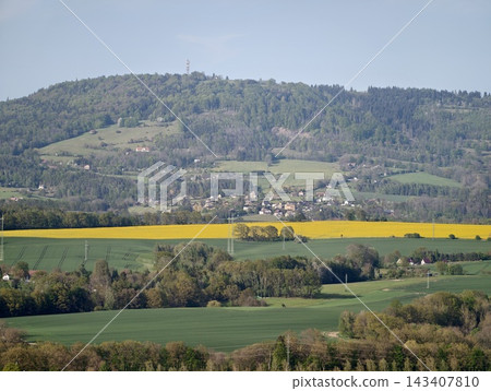 Vast scenic landscape. Expansive countryside with layered patches and rolling hills showcasing color Vast scenic landscape. Expansive countryside with layered patches and rolling hills showcasing color 143407810