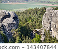Secluded canyon with towering cliffs. Remote forested gorge featuring steep vertical rocks and shaded areas 143407844