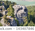 Skyward rocky clusters. Aerial perspective showcasing rugged terrain among forested hills and distant plains 143407846