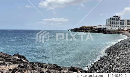 A Beautiful Serene Coastal View Featuring a Hotel and a Rocky Shoreline for Everyone to Enjoy A Beautiful Serene Coastal View Featuring a Hotel and a Rocky Shoreline for Everyone to Enjoy 143408041