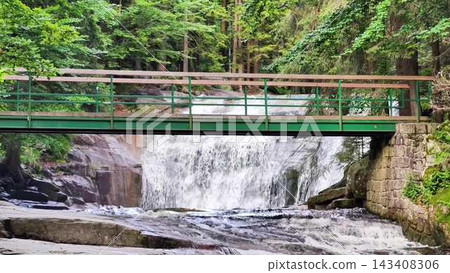 A Serene Waterfall with a Beautiful Bridge in a Lush Forest Setting, Radiating Harmony A Serene Waterfall with a Beautiful Bridge in a Lush Forest Setting, Radiating Harmony 143408306