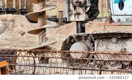 Heavy Machinery Utilized in Construction Projects Featuring the Versatile Auger Drill Heavy Machinery Utilized in Construction Projects Featuring the Versatile Auger Drill 143408327