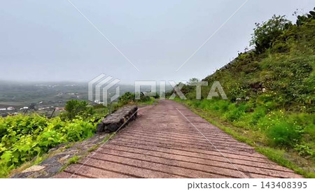 A Beautiful, Scenic Pathway That Meanders Gently Through Lush, Green Hills on a Misty, Lovely Day A Beautiful, Scenic Pathway That Meanders Gently Through Lush, Green Hills on a Misty, Lovely Day 143408395