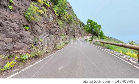 A Winding Road That is Surrounded by Lush Nature and Stretched Along a Beautiful Cliffside A Winding Road That is Surrounded by Lush Nature and Stretched Along a Beautiful Cliffside 143408492