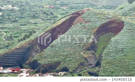 A Beautiful Eroded Mountain Landscape Showcasing Terraced Farming Along with Various Vegetation 143408518