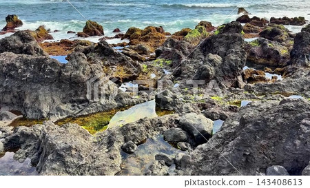 A beautiful Rocky Coastal Landscape featuring Tide Pools alongside Ocean Waves gently crashing A beautiful Rocky Coastal Landscape featuring Tide Pools alongside Ocean Waves gently crashing 143408613