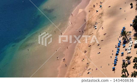 Enjoying a Beautiful Aerial View of a Stunning Tropical Beach with Clear Waters on a Perfect Day Enjoying a Beautiful Aerial View of a Stunning Tropical Beach with Clear Waters on a Perfect Day 143408636