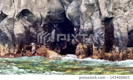 A breathtaking coastal rock formation is nestled beside stunning turquoise waters, offering beauty A breathtaking coastal rock formation is nestled beside stunning turquoise waters, offering beauty 143408665