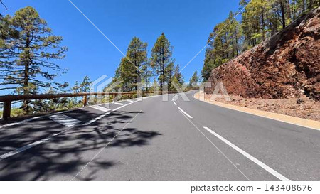 Winding Mountain Road Majestically Surrounded by Lush Green Trees and Idyllic Scenery Winding Mountain Road Majestically Surrounded by Lush Green Trees and Idyllic Scenery 143408676