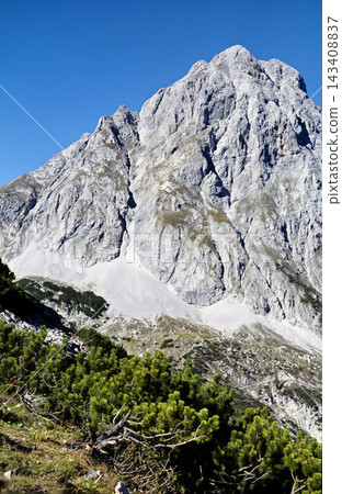 Majestic Sonnenspitze Mountain Peak with Lush Greenery Below, Austria Majestic Sonnenspitze Mountain Peak with Lush Greenery Below, Austria 143408837
