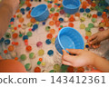 孩子的小手抓起五彩繽紛的超級球 143412361