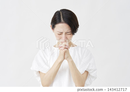 A middle-aged woman pleading against a white background. A middle-aged woman pleading against a white background. 143412717