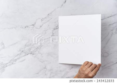 Top view sequence from open to close blank white greeting card mockup on marble background with copy space : hand opening a blank white folded greeting card Top view sequence from open to close blank white greeting card mockup on marble background with copy space : hand opening a blank white folded greeting card 143412833
