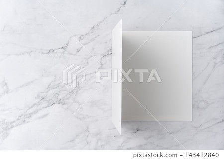 Top view sequence from open to close blank white greeting card mockup on marble background with copy space : opening a blank white folded greeting card Top view sequence from open to close blank white greeting card mockup on marble background with copy space : opening a blank white folded greeting card 143412840