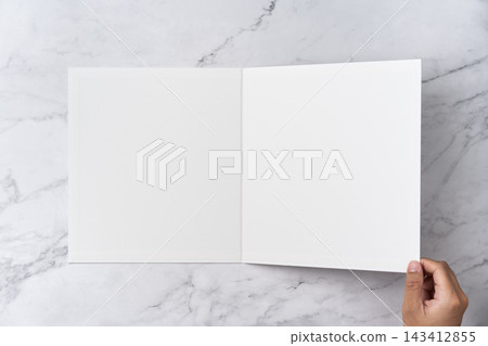 Top view sequence from open to close blank white greeting card mockup on marble background with copy space : hand closing a blank white folded greeting card Top view sequence from open to close blank white greeting card mockup on marble background with copy space : hand closing a blank white folded greeting card 143412855