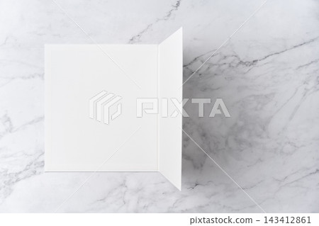 Top view sequence from open to close blank white greeting card mockup on marble background with copy space : closing a blank white folded greeting card Top view sequence from open to close blank white greeting card mockup on marble background with copy space : closing a blank white folded greeting card 143412861