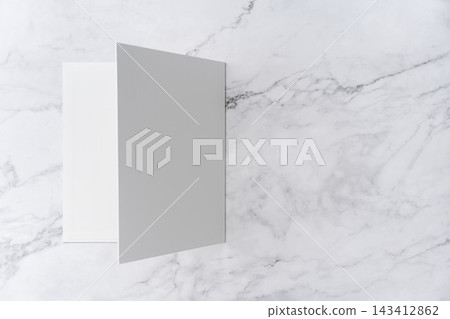 Top view sequence from open to close blank white greeting card mockup on marble background with copy space : closing a blank white folded greeting card Top view sequence from open to close blank white greeting card mockup on marble background with copy space : closing a blank white folded greeting card 143412862