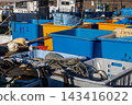 Blue and yellow fishing containers piled up at the fishing port 143416022