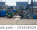 Fishing boats lined up along the pier and mooring ropes. 143416024