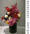 A gorgeous Japanese-style New Year's flower arrangement in a bamboo vase. 143416248
