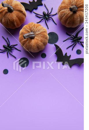 Halloween pumpkins, bats, and spiders on purple background 143417208