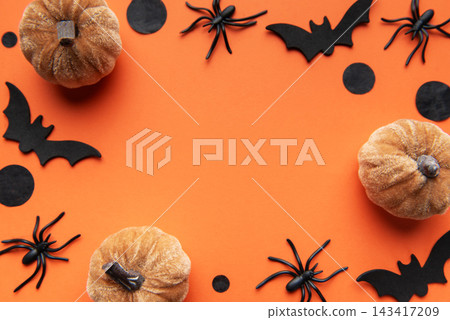 Halloween decor with pumpkins, spiders, bats on orange background Halloween decor with pumpkins, spiders, bats on orange background 143417209