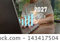 2027 growth projection concept with laptop and holographic rocket icons for business success templates 143417504
