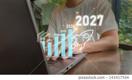 2027 growth projection concept with laptop and holographic rocket icons for business success templates 143417504