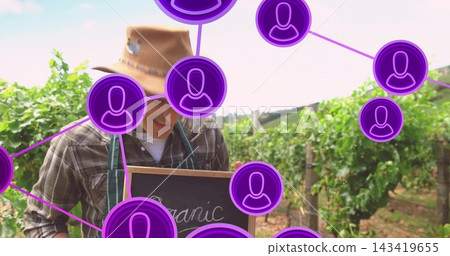 Holding Organic sign, vintner wearing hat, apron in vines, purple icons appearing selling grapes Holding Organic sign, vintner wearing hat, apron in vines, purple icons appearing selling grapes 143419655