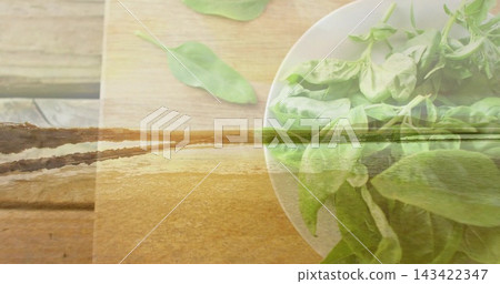 Showing white bowl of green salad leaves sitting on wooden tabletop, shoreline overlay, copy space Showing white bowl of green salad leaves sitting on wooden tabletop, shoreline overlay, copy space 143422347