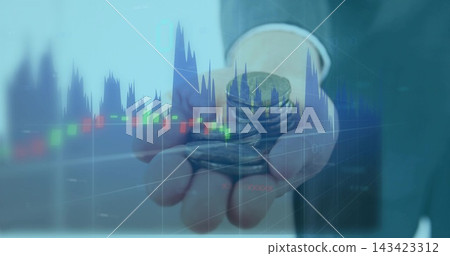 Holding right hand showing stack and loose coins at corporate studio, with suit cuff and charts 143423312