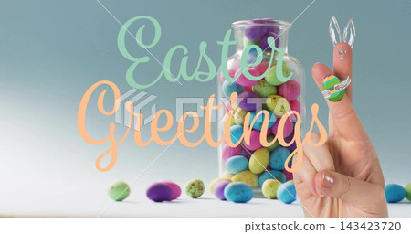 Displaying jar and two finger bunnies forming on table with speckled eggs, Easter Greetings text Displaying jar and two finger bunnies forming on table with speckled eggs, Easter Greetings text 143423720
