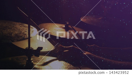 Striking drummer's hands playing cymbals on stage, holding drumsticks, wearing dark sleeves Striking drummer's hands playing cymbals on stage, holding drumsticks, wearing dark sleeves 143423952