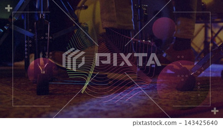 Glowing drum kit showing rubber-capped spurs, pedal axle and cables on carpeted stage with overlay Glowing drum kit showing rubber-capped spurs, pedal axle and cables on carpeted stage with overlay 143425640