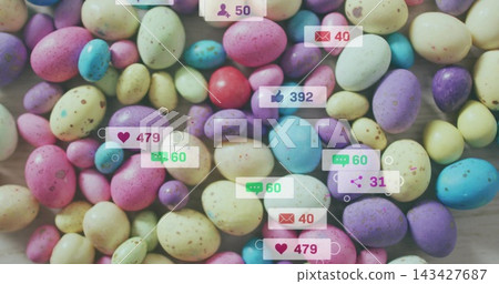 Covering dense cluster of pastel speckled candy eggs on light wood tabletop, showing social badges Covering dense cluster of pastel speckled candy eggs on light wood tabletop, showing social badges 143427687