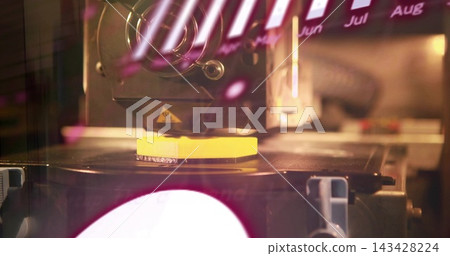 Printing extruder nozzle building yellow part on heated plate in workshop, showing warning decal Printing extruder nozzle building yellow part on heated plate in workshop, showing warning decal 143428224