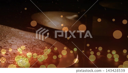 Shimmering front drum cymbal showing droplets with rear cymbal blur on stage, with stand and bokeh Shimmering front drum cymbal showing droplets with rear cymbal blur on stage, with stand and bokeh 143428539