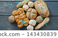 Displaying challah, baguette, seeded and scored loaves on bakery counter with cyan hex overlays 143430839