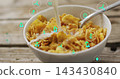 Pouring milk into white bowl of cornflakes with metal spoon on rustic table, showing AR icons 143430840