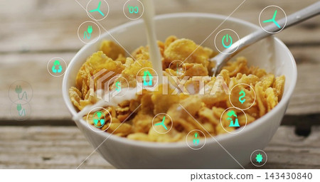 Pouring milk into white bowl of cornflakes with metal spoon on rustic table, showing AR icons Pouring milk into white bowl of cornflakes with metal spoon on rustic table, showing AR icons 143430840