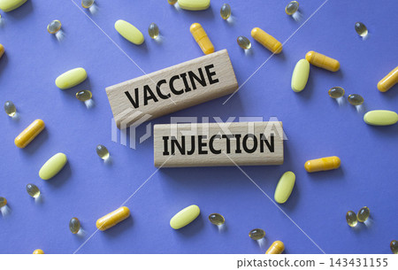 Vaccine Injection symbol. Concept word Vaccine Injection on wooden blocks. Beautiful purple background with pills. Medicine and Vaccine Injection. Copy space Vaccine Injection symbol. Concept word Vaccine Injection on wooden blocks. Beautiful purple background with pills. Medicine and Vaccine Injection. Copy space 143431155