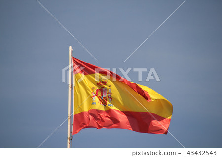 Flag of Spain aganist blue sky Flag of Spain aganist blue sky 143432543