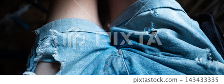 Ripped blue denim fabric clothing fashion banner 143433335