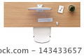 A desktop setup with a monitor, keyboard, mouse, notepad, and plant on a wooden desk. The layout is simple and clear, arranged neatly for work 143433657