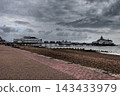 A rare glimpse of Eastbourne Pier and the coastline before the fire, under a cloudy sky - England 143433979