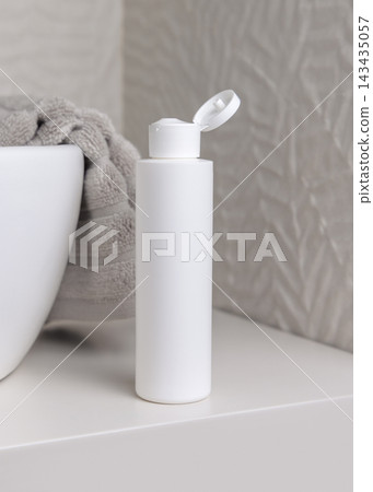 White flip top bottle mockup near grey towel in beige bathroom, unbranded cosmetic packaging White flip top bottle mockup near grey towel in beige bathroom, unbranded cosmetic packaging 143435057