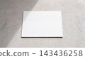 Minimalist white paper mockup sheet resting on a textured concrete surface under sunlight with concrete minimalist sunlight stationery presentation corporate business branding identity 143436258